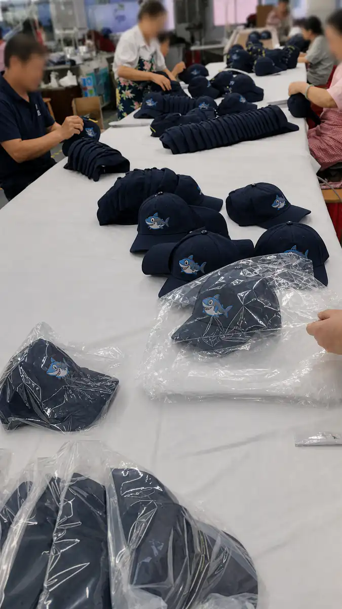 Anonymized production of shark embroidered navy nylon baseball caps