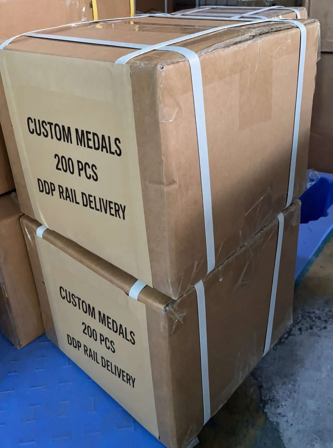 Anonymized cartons containing 200 custom medals prepared for DDP railway delivery