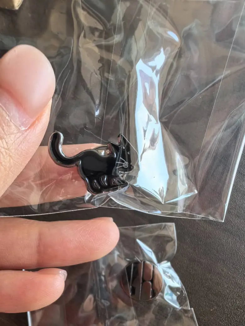 Cat-shaped band pin packed in a clear individual OPP bag