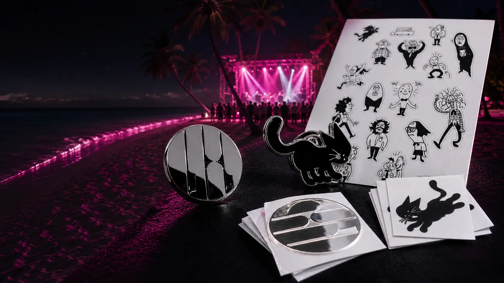 Two custom enamel pins and two sticker formats arranged at a Maldives beach concert