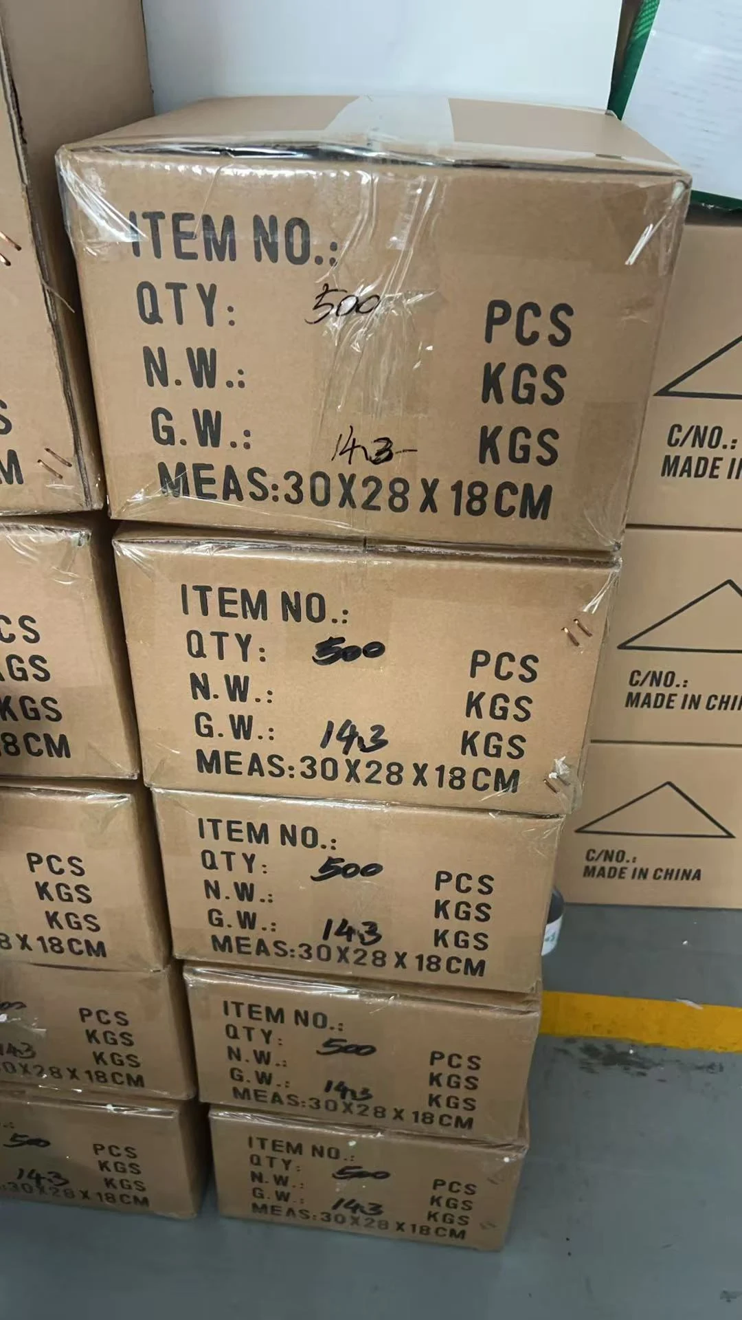 Cartons of custom bottle-opener magnets marked 500 pieces per carton